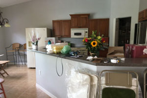 High ceilings with harsh recessed fixtures in kitchen