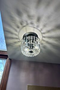 Installed new chandelier in bathroom over tub.