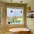 Pendant lights over claw foot bathtub.